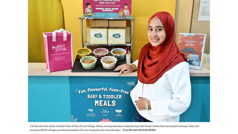 The founder of Plate & Play, a pioneer in baby led weaning ready made meals,  stands in front of their varied, curated menu for babies and toddlers aged 6months and above.